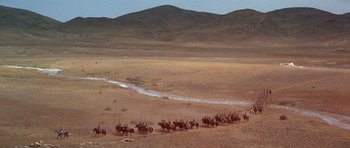 Movie still from “Young Winston” (1972), directed by Richard Attenborough – A herd of horses running across a dry desert land; Extreme Wide shot, High angle