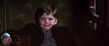 Movie still from “Young Winston” (1972), directed by Richard Attenborough – A young boy wearing a jacket and a tie; Close Up shot, Low angle
