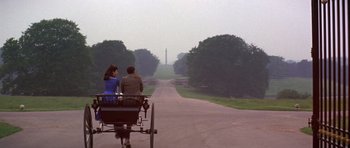 Movie still from “Young Winston” (1972), directed by Richard Attenborough – A man and a woman riding in a carriage down a road; Wide shot, High angle