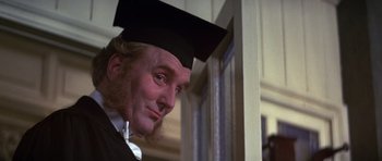 Movie still from “Young Winston” (1972), directed by Richard Attenborough – A person wearing a cap and gown; Close Up shot, Over the shoulder angle