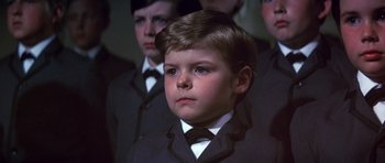 Movie still from “Young Winston” (1972), directed by Richard Attenborough – A young boy in a suit and bow tie; Close Up shot, High angle