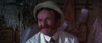 Movie still from “Young Winston” (1972), directed by Richard Attenborough – A person wearing a hat with a mustache; Close Up shot, Low angle