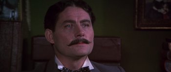 Movie still from “Young Winston” (1972), directed by Richard Attenborough – A person wearing a suit and tie; Close Up shot, Low angle