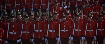Movie still from “Young Winston” (1972), directed by Richard Attenborough – A large group of men in red and white uniforms; Wide shot, High angle