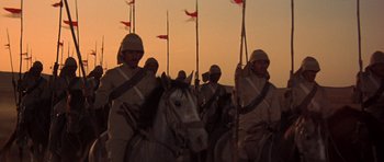 Movie still from “Young Winston” (1972), directed by Richard Attenborough – A group of men on horses with flags; Wide shot, Low angle