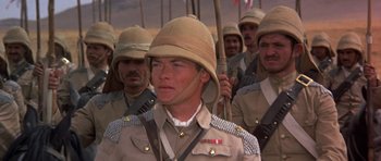 Movie still from “Young Winston” (1972), directed by Richard Attenborough – A group of men in military uniforms marching together; Close Up shot, High angle
