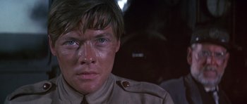 Movie still from “Young Winston” (1972), directed by Richard Attenborough – A person wearing a military uniform; Close Up shot, Low angle