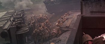 Movie still from “Young Winston” (1972), directed by Richard Attenborough – A group of men in military uniforms on top of a train track; Wide shot, High angle