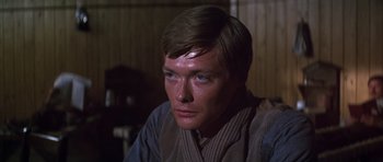Movie still from “Young Winston” (1972), directed by Richard Attenborough – A person wearing a suit and tie; Close Up shot, Low angle