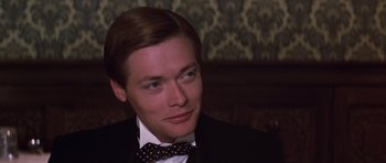Movie still from “Young Winston” (1972), directed by Richard Attenborough – A man in a suit and a bow tie; Close Up shot, High angle