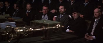 Movie still from “Young Winston” (1972), directed by Richard Attenborough – A group of men in suits sitting around a table; Medium shot, High angle