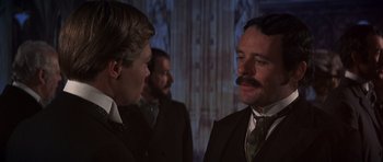Movie still from “Young Winston” (1972), directed by Richard Attenborough – A man in a suit talking to another man in a suit; Close Up shot, Over the shoulder angle