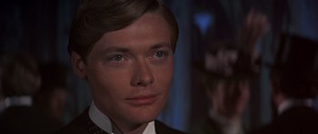Movie still from “Young Winston” (1972), directed by Richard Attenborough – A person wearing a suit and tie; Close Up shot, Over the shoulder angle