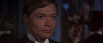 Movie still from “Young Winston” (1972), directed by Richard Attenborough – A person wearing a suit and tie; Close Up shot, Over the shoulder angle