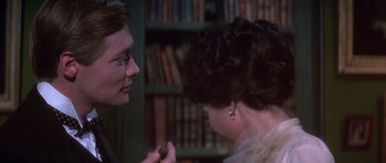 Movie still from “Young Winston” (1972), directed by Richard Attenborough – A man and a woman in a room with bookshelves; Close Up shot, Over the shoulder angle