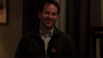 Movie still from “Your Sister's Sister” (2011), directed by Lynn Shelton – A man smiling for the camera in front of a curtain; Close Up shot, High angle