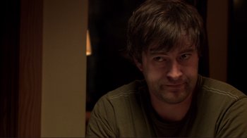 Movie still from “Your Sister's Sister” (2011), directed by Lynn Shelton – A person sitting in front of a wall; Close Up shot, Over the shoulder angle