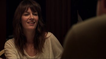 Movie still from “Your Sister's Sister” (2011), directed by Lynn Shelton – A woman sitting in front of a mirror smiling; Close Up shot, Over the shoulder angle