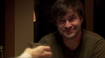 Movie still from “Your Sister's Sister” (2011), directed by Lynn Shelton – A person holding a cup of coffee; Close Up shot, Over the shoulder angle