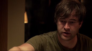 Movie still from “Your Sister's Sister” (2011), directed by Lynn Shelton – A person sitting at a table; Close Up shot, Over the shoulder angle