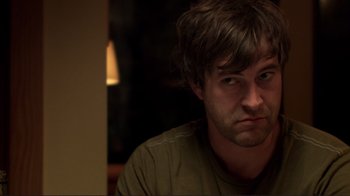 Movie still from “Your Sister's Sister” (2011), directed by Lynn Shelton – A person sitting down with his eyes wide open; Close Up shot, Over the shoulder angle