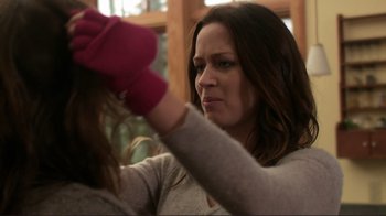 Movie still from “Your Sister's Sister” (2011), directed by Lynn Shelton – A woman is putting a red glove on her head; Close Up shot, Over the shoulder angle
