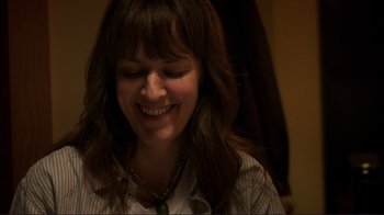 Movie still from “Your Sister's Sister” (2011), directed by Lynn Shelton – A person with a necklace smiling; Close Up shot, Over the shoulder angle