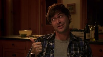Movie still from “Your Sister's Sister” (2011), directed by Lynn Shelton – A man giving a thumbs up while wearing a plaid shirt; Medium shot, Over the shoulder angle