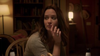 Movie still from “Your Sister's Sister” (2011), directed by Lynn Shelton – A woman sitting at a table with a plate of food in front of her face; Close Up shot, Over the shoulder angle
