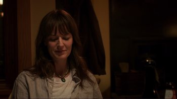 Movie still from “Your Sister's Sister” (2011), directed by Lynn Shelton – A woman with her eyes closed sitting in a dark room; Close Up shot, Over the shoulder angle