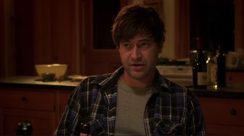 Movie still from “Your Sister's Sister” (2011), directed by Lynn Shelton – A man in a plaid shirt is sitting in a kitchen; Medium shot, Over the shoulder angle
