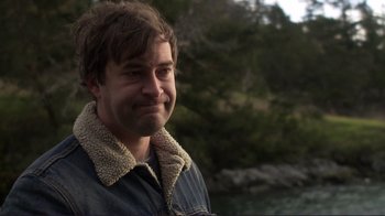 Movie still from “Your Sister's Sister” (2011), directed by Lynn Shelton – A person wearing a jacket near a body of water; Close Up shot, Over the shoulder angle