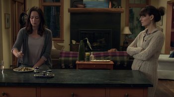 Movie still from “Your Sister's Sister” (2011), directed by Lynn Shelton – Two people sitting at a counter in a living room; Wide shot, Over the shoulder angle