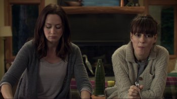 Movie still from “Your Sister's Sister” (2011), directed by Lynn Shelton – Two women sitting at a table in front of a fireplace; Medium shot, Over the shoulder angle