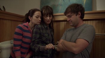 Movie still from “Your Sister's Sister” (2011), directed by Lynn Shelton – A man and two women looking at a pair of shears; Medium shot, Low angle