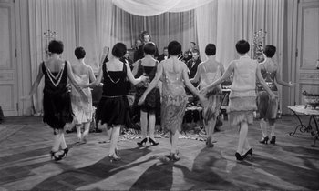 Movie still from “Yoyo” (1965), directed by Pierre Étaix – A group of women are dancing on a dance floor; Wide shot, High angle