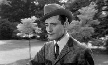 Movie still from “Yoyo” (1965), directed by Pierre Étaix – A man in a suit and a cowboy hat; Close Up shot, Low angle