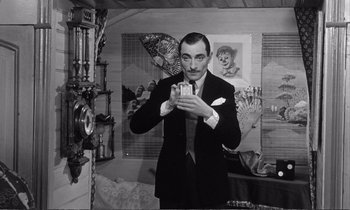 Movie still from “Yoyo” (1965), directed by Pierre Étaix – A black and white photo of a man taking a picture of himself; Medium shot, Low angle