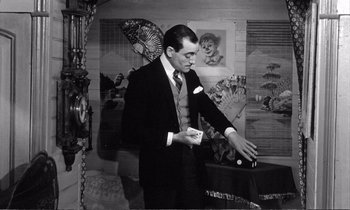 Movie still from “Yoyo” (1965), directed by Pierre Étaix – A black and white photo of a man in a suit and tie; Medium shot, Low angle