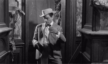 Movie still from “Yoyo” (1965), directed by Pierre Étaix – A black and white photo of a man wearing a suit and a hat; Medium shot, High angle