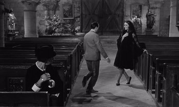 Movie still from “Yoyo” (1965), directed by Pierre Étaix – A man and a woman walking down the aisle of a church; Wide shot, High angle