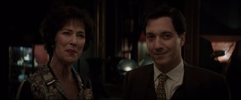 Movie still from “Yves Saint Laurent” (2014), directed by Jalil Lespert – A man and a woman standing next to each other; Close Up shot, Over the shoulder angle