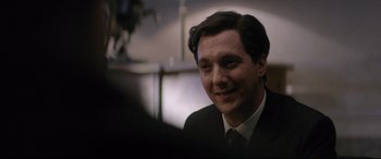 Movie still from “Yves Saint Laurent” (2014), directed by Jalil Lespert – A person wearing a suit and tie; Close Up shot, Over the shoulder angle
