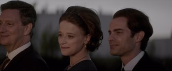 Movie still from “Yves Saint Laurent” (2014), directed by Jalil Lespert – A man and a woman standing next to each other; Close Up shot, Over the shoulder angle