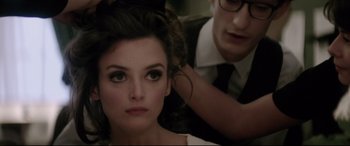 Movie still from “Yves Saint Laurent” (2014), directed by Jalil Lespert – A woman getting her hair done by a man; Close Up shot, Over the shoulder angle