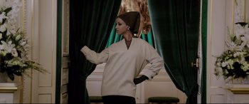 Movie still from “Yves Saint Laurent” (2014), directed by Jalil Lespert – A woman standing in front of a green drape; Medium shot, Low angle