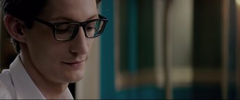 Movie still from “Yves Saint Laurent” (2014), directed by Jalil Lespert – A man wearing glasses looking down at his face; Close Up shot, Low angle