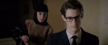 Movie still from “Yves Saint Laurent” (2014), directed by Jalil Lespert – A man and a woman are standing together; Close Up shot, Over the shoulder angle