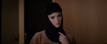 Movie still from “Yves Saint Laurent” (2014), directed by Jalil Lespert – A woman with a black head covering on her head; Close Up shot, Low angle