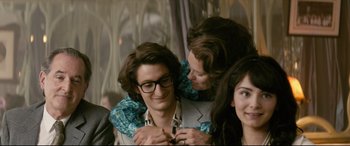 Movie still from “Yves Saint Laurent” (2014), directed by Jalil Lespert – A group of young people posing for a picture; Medium shot, Over the shoulder angle